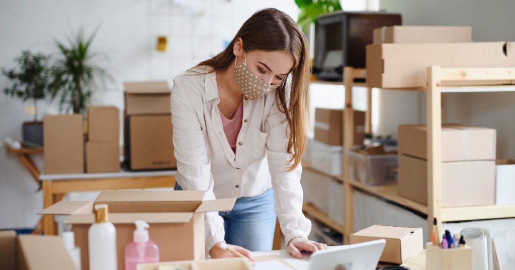 A women in a mask is dropshipping her print on demand items.