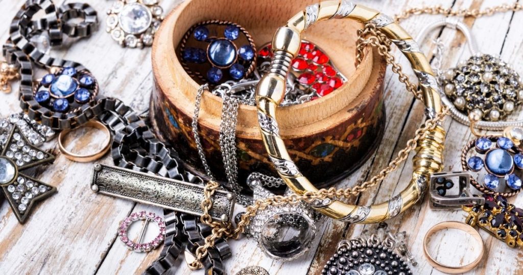 a lot of different accessories and jewellery on a wooden surface.