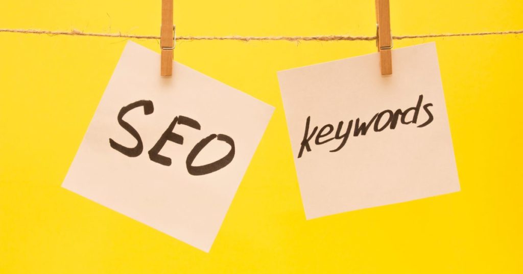 askıda kağıt üzerinde asılı SEO ve Keywords yazıları.